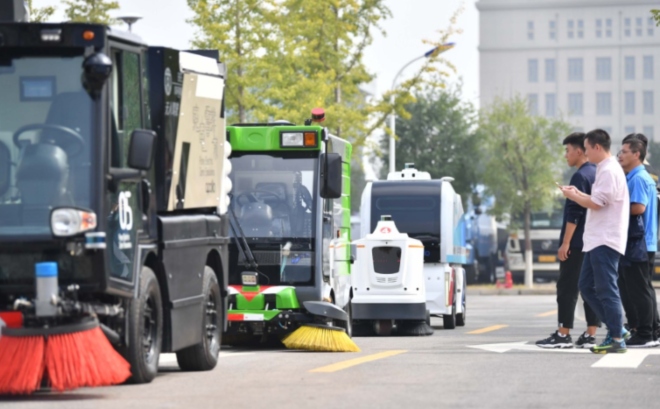 Sept véhicules autonomes de maintenance urbaine, développés par le géant chinois de la recherche sur internet Baidu Inc, balayent les routes du district de Shunyi, à Pékin, en septembre. [Photo by Yuan Yi/For China Daily]